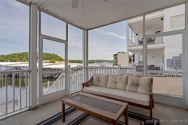 275 Flynn Rd Unit 105, Lake Ozark, MO 65049 - sunroom with a water view, outdoor lounge area, ceiling fan, and healthy amount of natural light
