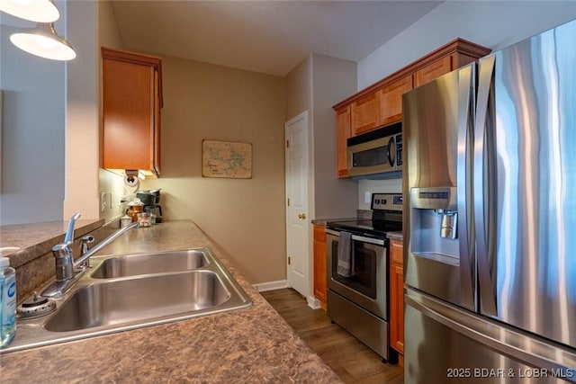 275 Flynn Rd Unit 105, Lake Ozark, MO 65049 - kitchen with stainless steel appliances, brown cabinetry, and wood finished floors