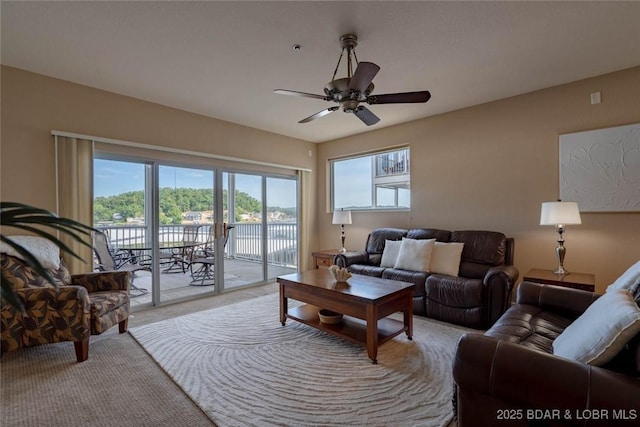 275 Flynn Rd Unit 105, Lake Ozark, MO 65049 - living room featuring plenty of natural light, light carpet, and a ceiling fan