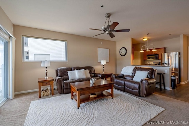 275 Flynn Rd Unit 105, Lake Ozark, MO 65049 - living area featuring healthy amount of natural light, a ceiling fan, and light carpet