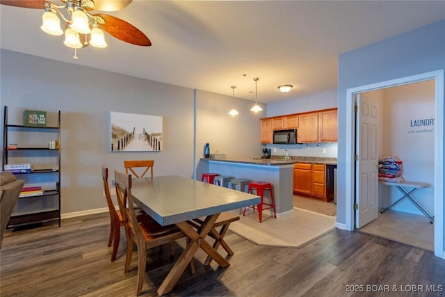 275 Flynn Rd Unit 105, Lake Ozark, MO 65049 - dining space with dark wood-style floors and ceiling fan