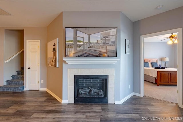 275 Flynn Rd Unit 105, Lake Ozark, MO 65049 - living room with wood finished floors, stairs, a fireplace, and a ceiling fan