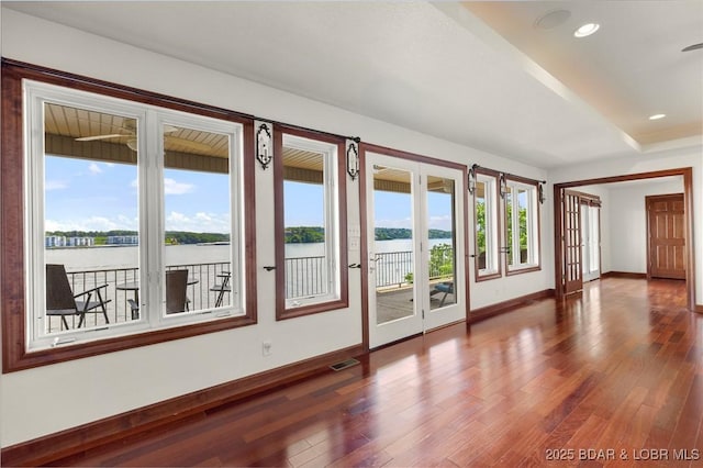 1129 Beacon Pointe Cir, Lake Ozark, MO 65049 - empty room with wood finished floors, a water view, french doors, and recessed lighting