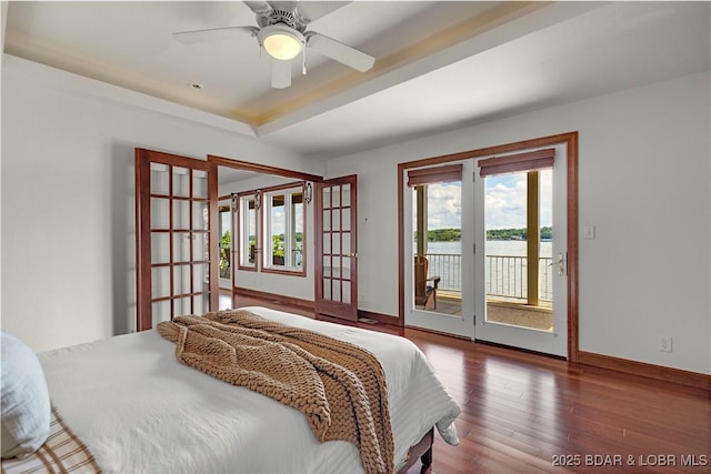 1129 Beacon Pointe Cir, Lake Ozark, MO 65049 - bedroom featuring access to exterior, wood finished floors, a tray ceiling, french doors, and ceiling fan