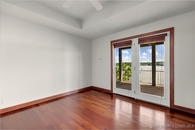 1129 Beacon Pointe Cir, Lake Ozark, MO 65049 - unfurnished room with wood finished floors, a raised ceiling, and ceiling fan
