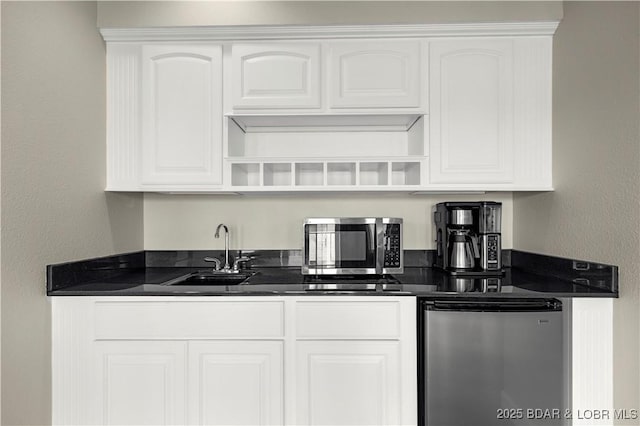 1129 Beacon Pointe Cir, Lake Ozark, MO 65049 - kitchen with open shelves, stainless steel microwave, refrigerator, and dark countertops
