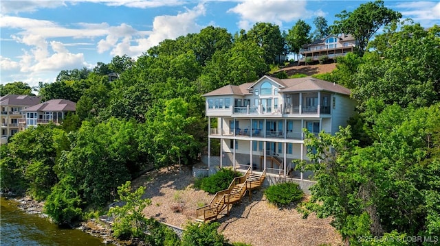 1129 Beacon Pointe Cir, Lake Ozark, MO 65049 - back of property featuring a balcony, stairway, a water view, and view of scattered trees
