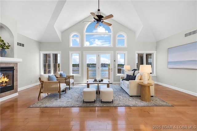 1129 Beacon Pointe Cir, Lake Ozark, MO 65049 - living room with ceiling fan, a fireplace, wood-type flooring, and high vaulted ceiling