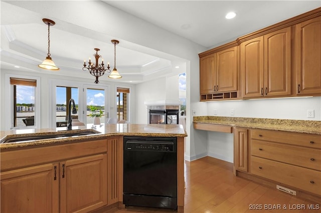1129 Beacon Pointe Cir, Lake Ozark, MO 65049 - kitchen featuring black dishwasher, a tray ceiling, light wood-style flooring, light stone counters, and pendant lighting