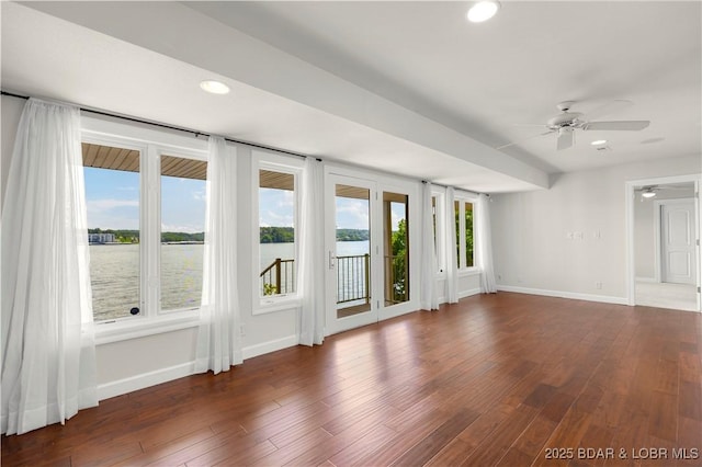 1129 Beacon Pointe Cir, Lake Ozark, MO 65049 - empty room with healthy amount of natural light, ceiling fan, a water view, wood finished floors, and recessed lighting