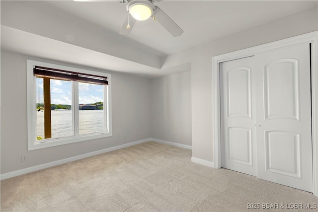 1129 Beacon Pointe Cir, Lake Ozark, MO 65049 - unfurnished bedroom featuring carpet flooring, a closet, and ceiling fan