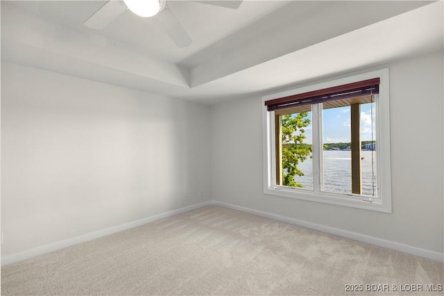1129 Beacon Pointe Cir, Lake Ozark, MO 65049 - unfurnished room featuring light carpet, ceiling fan, and a tray ceiling