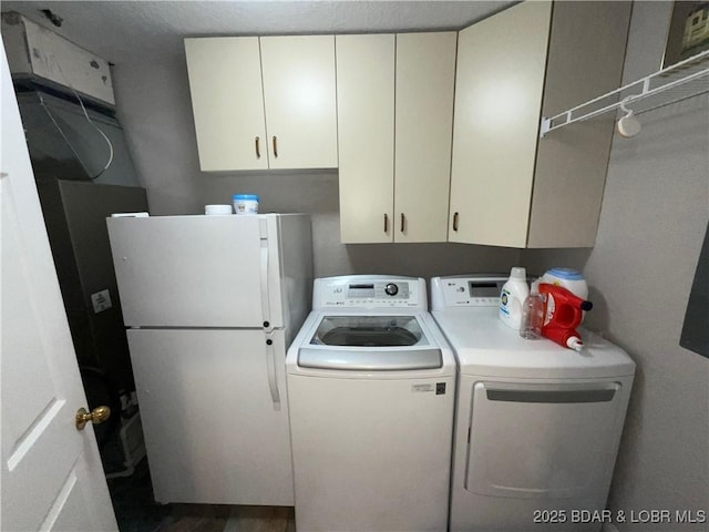 757 Malibu Rd Unit 101B, Osage Beach, MO 65065 - laundry room featuring washing machine and dryer and cabinet space