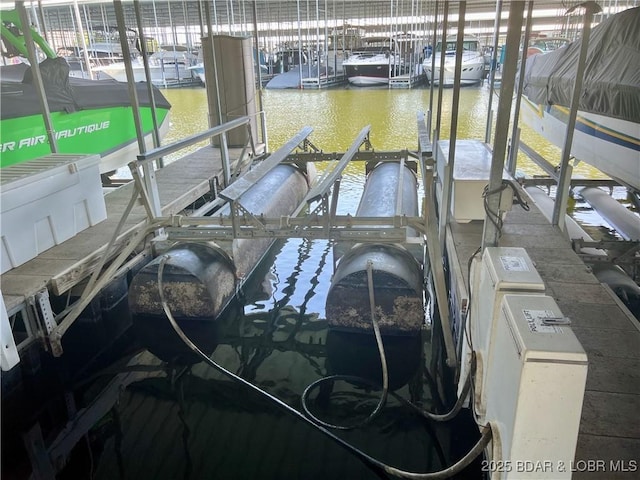 757 Malibu Rd Unit 101B, Osage Beach, MO 65065 - dock featuring boat lift, a water view, and view of marina
