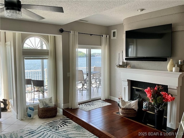757 Malibu Rd Unit 101B, Osage Beach, MO 65065 - living area featuring ceiling fan, a textured ceiling, and a large fireplace