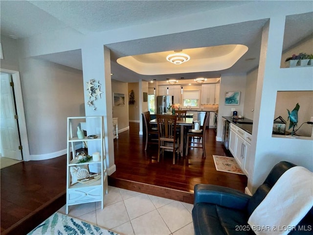 757 Malibu Rd Unit 101B, Osage Beach, MO 65065 - dining area with a tray ceiling and light tile patterned floors