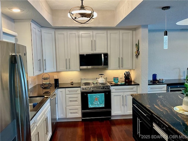 757 Malibu Rd Unit 101B, Osage Beach, MO 65065 - kitchen with stainless steel appliances, white cabinetry, dark wood-type flooring, and pendant lighting