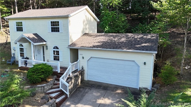 2096 Birchwood Ln, Osage Beach, MO 65065 - view of front of property with a porch, a garage, concrete driveway, and roof with shingles