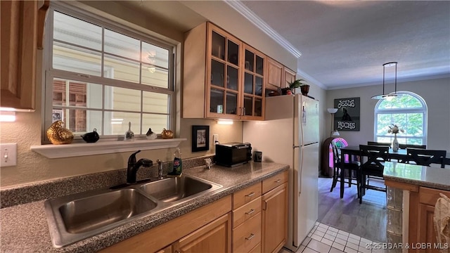 2096 Birchwood Ln, Osage Beach, MO 65065 - kitchen featuring ornamental molding, glass insert cabinets, freestanding refrigerator, dark countertops, and pendant lighting