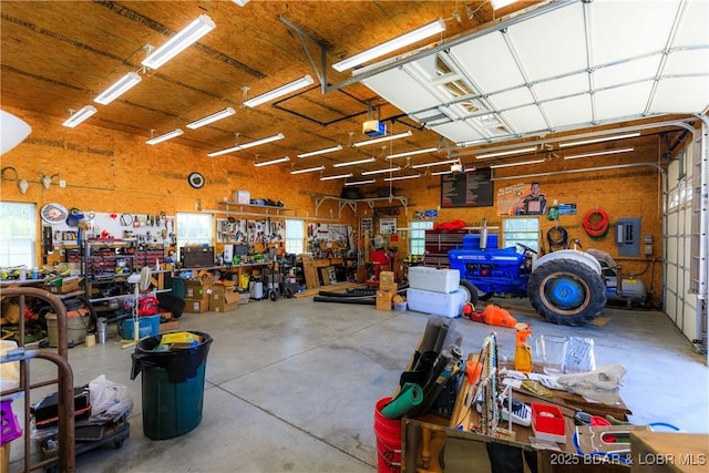 2174 State Road V, Linn Creek, MO 65052 - garage featuring a workshop area, a garage door opener, and electric panel
