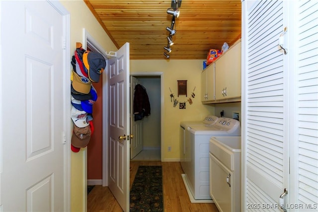 2174 State Road V, Linn Creek, MO 65052 - washroom with cabinet space, washer and dryer, rail lighting, light wood-style flooring, and wooden ceiling