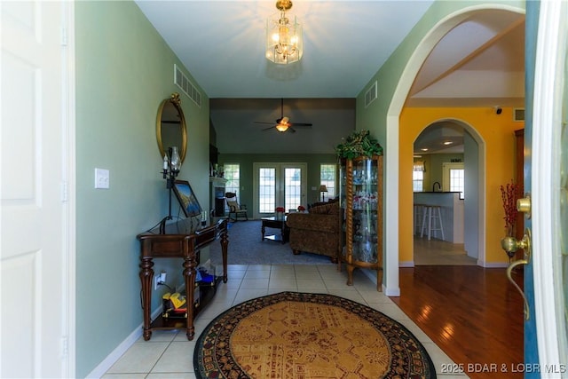 2174 State Road V, Linn Creek, MO 65052 - foyer featuring arched walkways, a ceiling fan, light tile patterned floors, and healthy amount of natural light