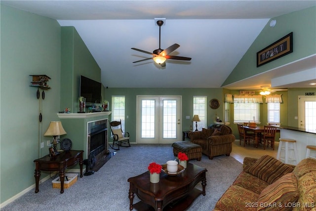 2174 State Road V, Linn Creek, MO 65052 - carpeted living area featuring a ceiling fan, a fireplace with flush hearth, and high vaulted ceiling