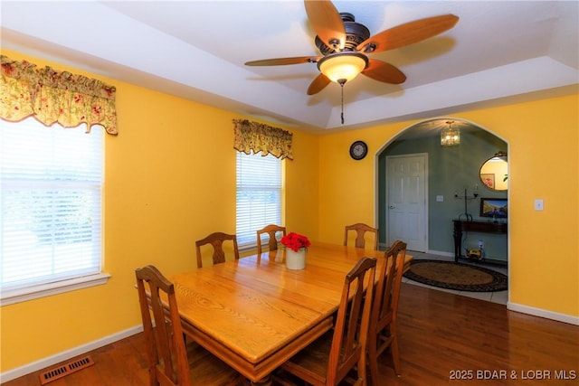 2174 State Road V, Linn Creek, MO 65052 - dining room with arched walkways, a tray ceiling, wood finished floors, and a ceiling fan
