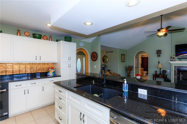 2174 State Road V, Linn Creek, MO 65052 - kitchen with arched walkways, tasteful backsplash, ceiling fan, dark stone counters, and white cabinets