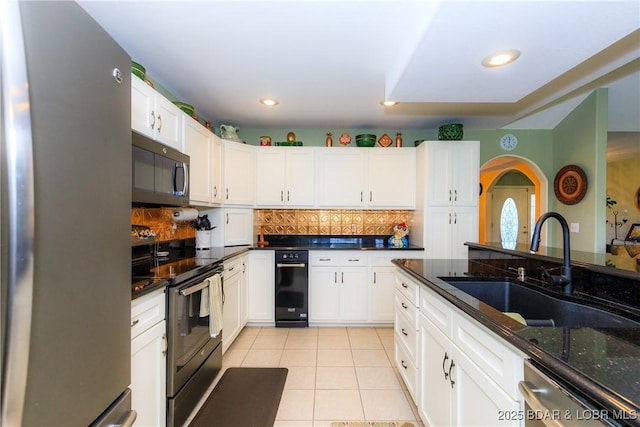 2174 State Road V, Linn Creek, MO 65052 - kitchen featuring stainless steel appliances, light tile patterned floors, decorative backsplash, white cabinetry, and recessed lighting