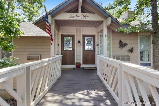 392 Hopetown Dr, Osage Beach, MO 65065 - property entrance with a shingled roof and a deck