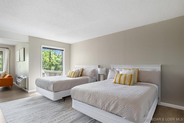 392 Hopetown Dr, Osage Beach, MO 65065 - bedroom with wood finished floors and a textured ceiling