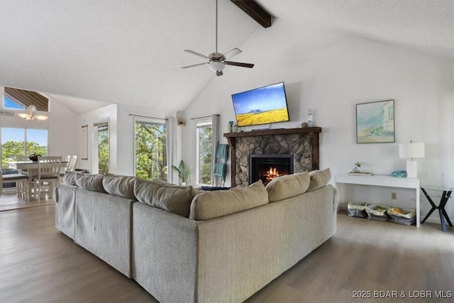 392 Hopetown Dr, Osage Beach, MO 65065 - living area featuring wood finished floors, high vaulted ceiling, a fireplace, healthy amount of natural light, and beamed ceiling