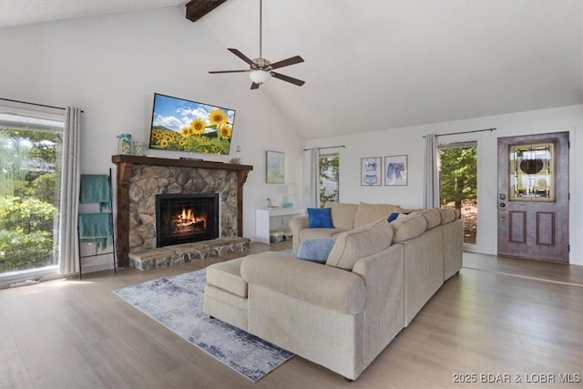 392 Hopetown Dr, Osage Beach, MO 65065 - living area featuring high vaulted ceiling, light wood-type flooring, a fireplace, beam ceiling, and ceiling fan