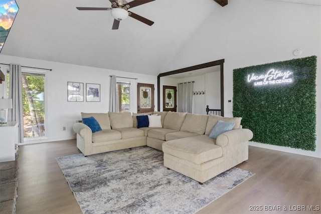 392 Hopetown Dr, Osage Beach, MO 65065 - living area featuring high vaulted ceiling, ceiling fan, wood finished floors, healthy amount of natural light, and beam ceiling