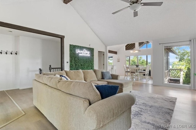 392 Hopetown Dr, Osage Beach, MO 65065 - living area with high vaulted ceiling, ceiling fan, and beamed ceiling