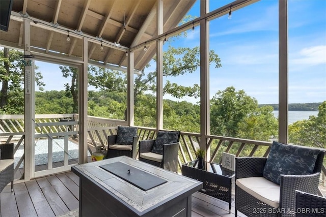 392 Hopetown Dr, Osage Beach, MO 65065 - sunroom / solarium with a water view, plenty of natural light, lofted ceiling, and an outdoor hangout area