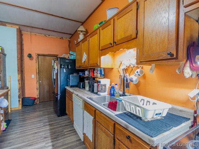 1727 Bollinger Creek Rd, Climax Springs, MO 65324 - kitchen featuring brown cabinets, light countertops, wood finished floors, freestanding refrigerator, and dishwasher