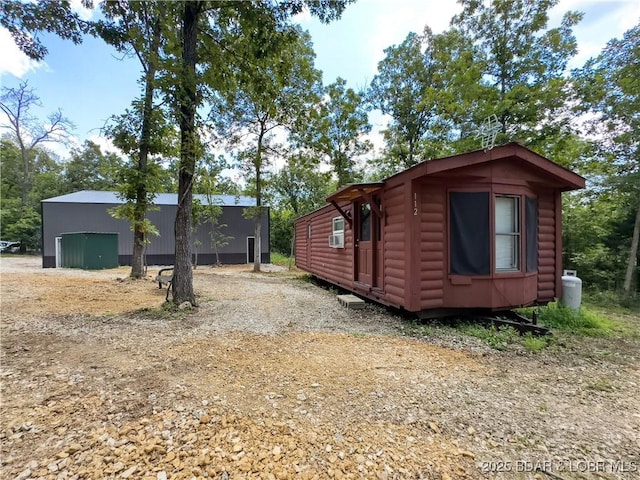 30424 Violet Rd, Gravois Mills, MO 65037 - view of home's exterior with an outbuilding and faux log siding