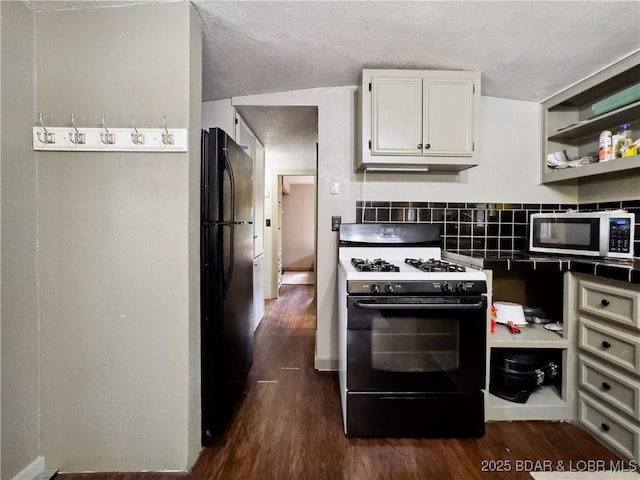 30424 Violet Rd, Gravois Mills, MO 65037 - kitchen featuring range with gas stovetop, stainless steel microwave, freestanding refrigerator, and dark wood-type flooring