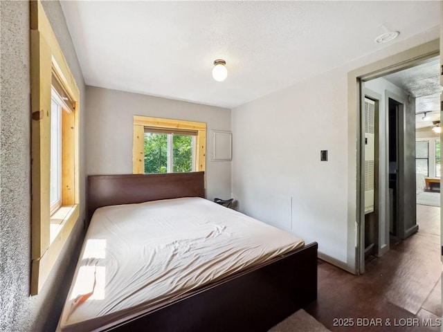 30424 Violet Rd, Gravois Mills, MO 65037 - bedroom with baseboards and wood finished floors