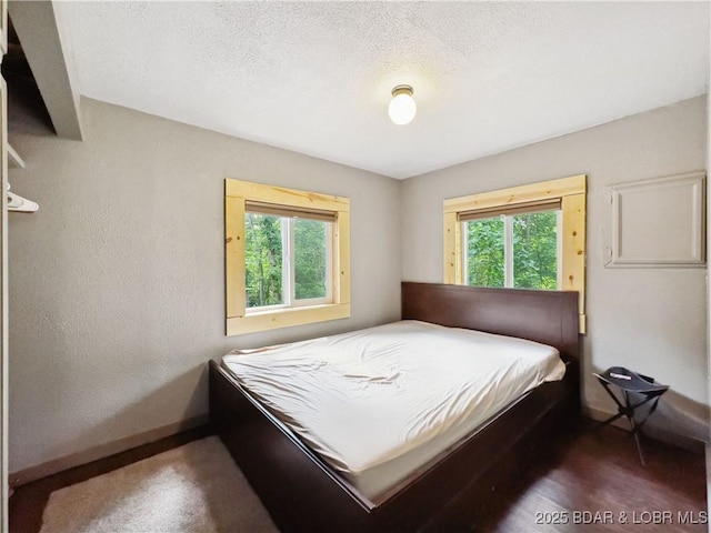 30424 Violet Rd, Gravois Mills, MO 65037 - bedroom with baseboards and a textured ceiling