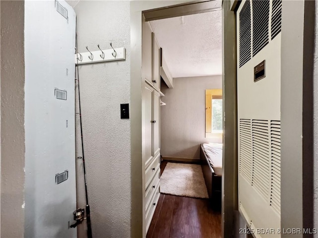 30424 Violet Rd, Gravois Mills, MO 65037 - hallway with a heating unit, dark wood finished floors, and a textured wall