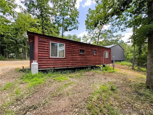 30424 Violet Rd, Gravois Mills, MO 65037 - view of side of property featuring log veneer siding
