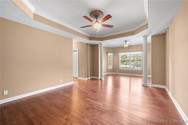 22 Hand Ln, Eldon, MO 65026 - unfurnished room featuring decorative columns, a tray ceiling, ceiling fan, light wood-type flooring, and ornamental molding