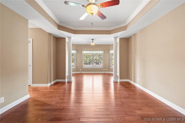 22 Hand Ln, Eldon, MO 65026 - empty room with ornate columns, ceiling fan, wood finished floors, ornamental molding, and a tray ceiling