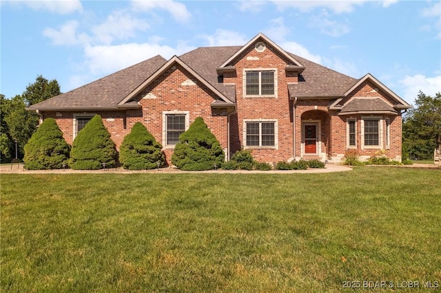 22 Hand Ln, Eldon, MO 65026 - traditional-style home with brick siding, a front lawn, and roof with shingles