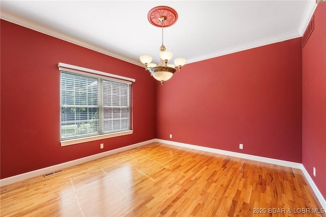 22 Hand Ln, Eldon, MO 65026 - unfurnished room with a chandelier, crown molding, and wood finished floors