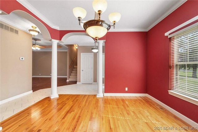 22 Hand Ln, Eldon, MO 65026 - empty room featuring decorative columns, wood finished floors, crown molding, stairs, and a ceiling fan