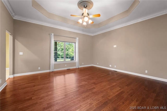 22 Hand Ln, Eldon, MO 65026 - spare room with a tray ceiling, ceiling fan, wood finished floors, and crown molding